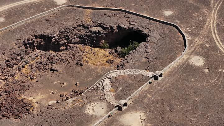 Natural landscapes, the Cave of Umm al-Jarsan in the Harrah of Khaybar north of Medina, ancient natural caves and caverns, carved rocks, tourist spots, natural views.