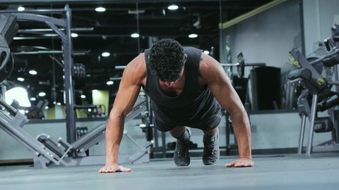 Youth physical activities to enhance fitness, build and strengthen body muscles, bodybuilding, a young Arab Gulf Saudi man wearing sportswear practicing exercises, a healthy lifestyle.