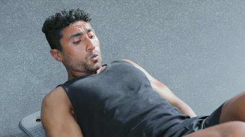 A youth exercise to maintain fitness, build and strengthen body muscles, bodybuilding, a young Arab Gulf Saudi man wearing sportswear practicing exercises, a healthy lifestyle.