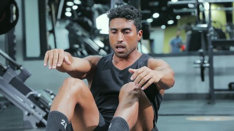 A youth practice that enhances physical fitness, builds and strengthens body muscles, bodybuilding, a young Arab Gulf Saudi man wearing sportswear is exercising, a healthy lifestyle.