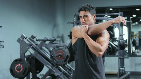Building and strengthening body muscles, bodybuilding, a young Arab Gulf Saudi man wearing sportswear practicing exercises, a healthy lifestyle, a youth activity that helps with physical fitness.