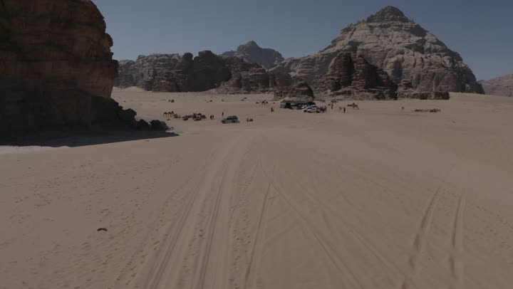 Outdoor camping and youth camping, interest in raising camels and dromedaries, drone photography for camel safari trips in the middle of the kingdom's desert, sand dunes and desert areas, the concept of livestock and mammal care, natural landscapes in deserts, mountain and rock formations.