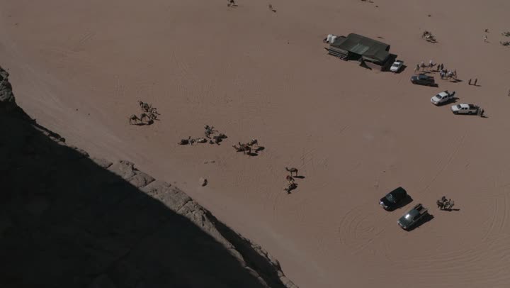 Outdoor camping and youth camping, interest in raising camels and dromedaries, drone photography for camel safari trips in the middle of the kingdom's desert, sand dunes and desert areas, the concept of livestock and mammal care, natural landscapes in deserts, mountain and rock formations.