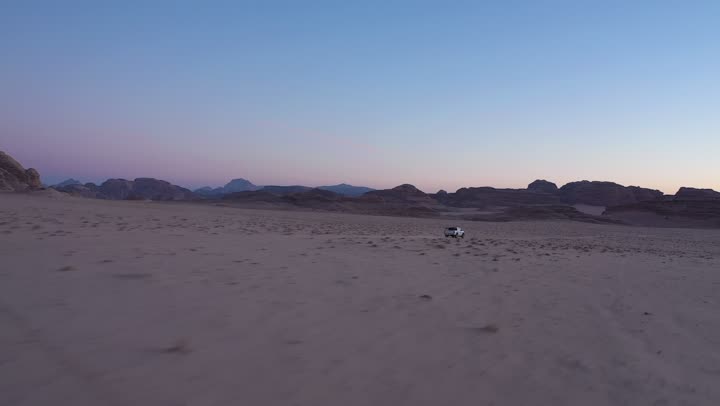 Driving on rough roads and sand dunes, traveling through deserts in the Kingdom of Saudi Arabia, means of transportation, using modern vehicles for fast land travel, desert nature and dry environment, drone photography for adventures and safari trips in the AlUla desert.