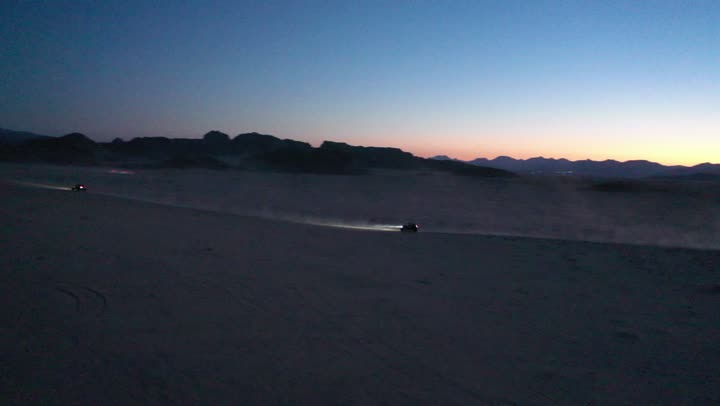 Driving on rough roads and sand dunes, traveling through deserts in the Kingdom of Saudi Arabia, means of transportation, using modern vehicles for fast land travel, desert nature and dry environment, drone photography for adventures and safari trips in the AlUla desert.