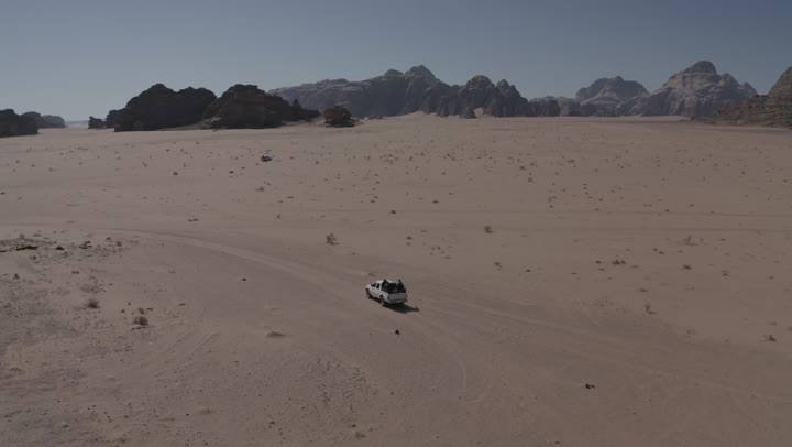 Driving on rough roads and sand dunes, traveling through deserts in the Kingdom of Saudi Arabia, means of transportation, using modern vehicles for fast land travel, desert nature and dry environment, drone photography for adventures and safari trips in the AlUla desert.