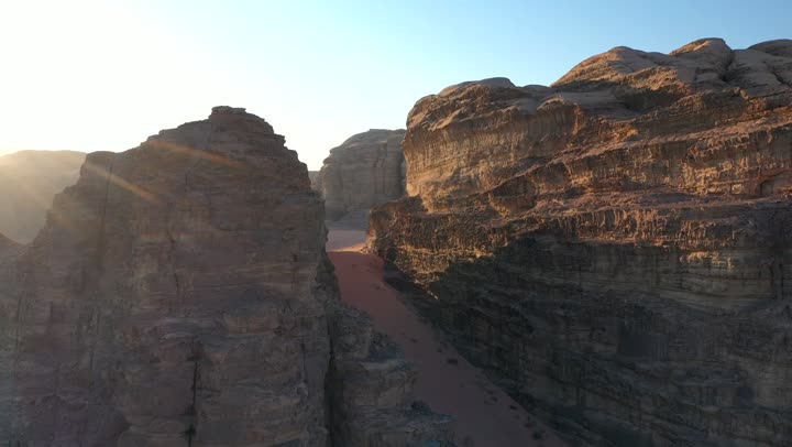 The natural rock formations in Madain Saleh in Al-Ula Governorate, Saudi Arabia, the desert and mountainous nature, drone photography of the mountains and rock formations in Al-Ula Governorate, historical archaeological tourist sites and landmarks.