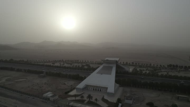 The architectural artistic design of Islamic structures and sculptures in Mecca, the most famous landmarks in the Kingdom during the daytime, aerial drone photography of the Quran Gate sculpture in Mecca shaped like the Holy Quran, sacred religious places, and the prepared and equipped roads in Saudi cities.