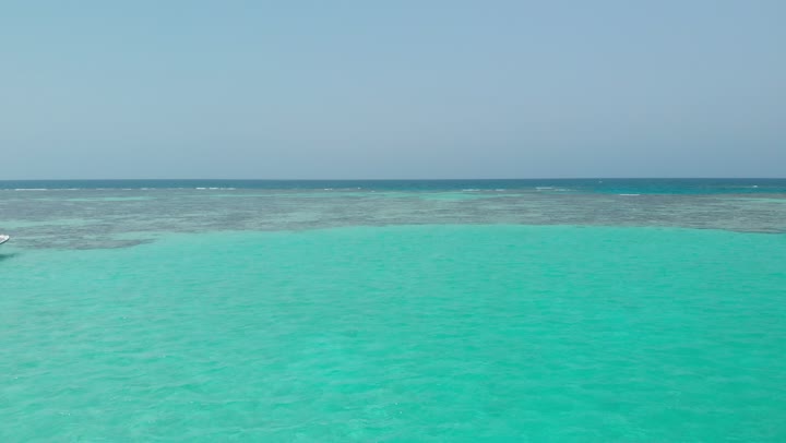 Distinctive landscapes, calm sea waves, famous tourist areas, crashing waves in the waters of the Red Sea in the Kingdom of Saudi Arabia, enjoying the coastal beaches, famous coastal places and tourist attractions, aerial drone photography of ships in the middle of the Red Sea.