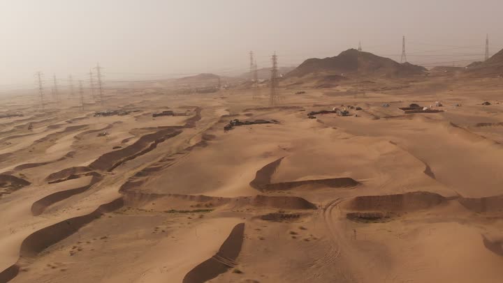 The formations and sand structures in the deserts, the harsh and dry climate in arid lands, spending time in the desert with friends, the landscapes and soft golden sands in the desert, the soft golden dunes and natural terrain in the Kingdom of Saudi Arabia, nature background.