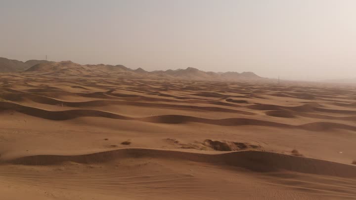 The formations and sand structures in the deserts, the harsh and dry climate in arid lands, spending time in the desert with friends, the landscapes and soft golden sands in the desert, the soft golden dunes and natural terrain in the Kingdom of Saudi Arabia, nature background.
