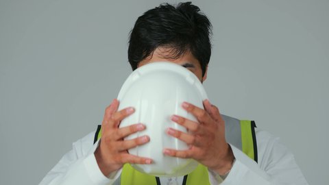 Working in the engineering sector, the concept of engineering and architectural constructions, standing with crossed arms, a close-up portrait of an Emirati Gulf Arab engineer wearing a kandura and work jacket, looking with gestures of joy and self-confidence, Emirati professions and jobs, construction by the hands of the nation's sons, white background.