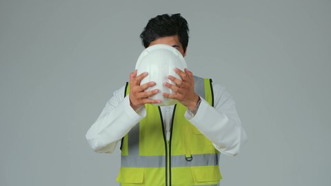 Standing with crossed arms, the concept of engineering and architectural construction, a portrait of an Emirati Gulf Arab engineer wearing a kandura and work jacket, looking with gestures of joy and self-confidence, working in the engineering sector, Emirati professions and jobs, construction by the hands of the nation's sons, white background.