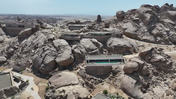 Interest in agriculture in sandy dune areas, a panoramic view of the rocky desert mountains, aerial drone photography of rock formations in the desert of Saudi Arabia, natural landscapes and phenomena, the coastal area of Umluj in Saudi Arabia, the texture of rocks on the face of the mountain, designated areas with a swimming pool.