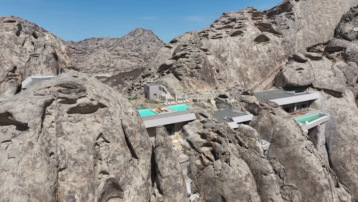 منظر بانورامي للجبال الصخرية الصحراوية، جزر في البحر الأحمر، تصوير درون جوي لجبال من التشكلات الصخرية في صحراء المملكة العربية السعودية، مناظر وظواهر طبيعية، أملج الساحلية في السعودية، نسيج الصخور على وجه الجبل، اماكن مخصصة فيها حوض سباحة