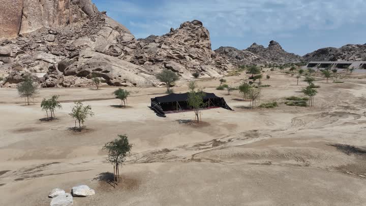 Natural landscapes and phenomena, the coastal area of Umluj in Saudi Arabia, the texture of rocks on the face of the mountain, attention to agriculture in sandy dune areas, a panoramic view of the rocky desert mountains, drone photography of mountains with rock formations in the desert of the Kingdom of Saudi Arabia with black tents.