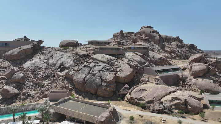 Interest in agriculture in sandy dune areas, a panoramic view of the rocky desert mountains, aerial drone photography of rock formations in the desert of Saudi Arabia, natural landscapes and phenomena, the coastal area of Umluj in Saudi Arabia, the texture of rocks on the face of the mountain, designated areas with a swimming pool.