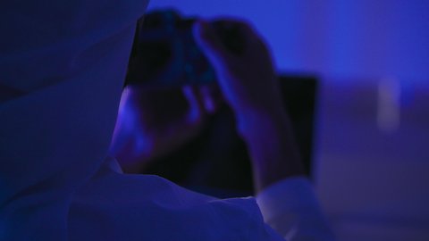 Learn to take artistic snapshots, master and professionalize the photography profession, passionately practice your favorite hobby, a close-up shot from behind of an Emirati Gulf Arab man holding a camera in his hands, using advanced modern techniques.