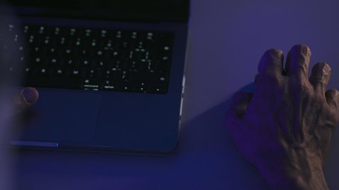 Administrative and office jobs, integrating modern technology into practical life, the concept of data entry, content creation, a close-up shot of the hand of an Arab Gulf Saudi man using a laptop mouse, working on a laptop.