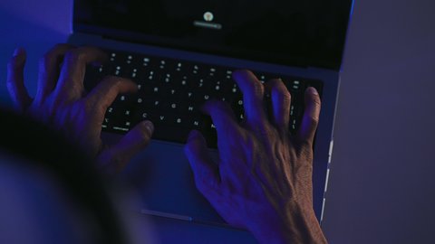 Integrating work with technology and tech, tasks of administrative office jobs, data entry and typing through the keyboard, possessing the skill of fast typing on the keyboard, a close-up shot of the hands of a Saudi Gulf Arab man working on a laptop.