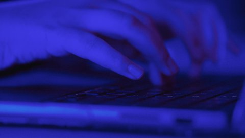 Data entry and typing on the keyboard, possessing the skill of fast typing on the keyboard, integrating work with technology and tech, tasks of administrative office jobs, a close-up shot of the hand of a Saudi Arabian Gulf woman working on a laptop.