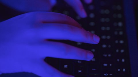 Using the keyboard to input information, possessing the skill of fast typing on the keyboard, integrating work with technology and tech, tasks of administrative office jobs, a close-up shot of the hand of a Saudi Arabian Gulf woman working on a laptop.