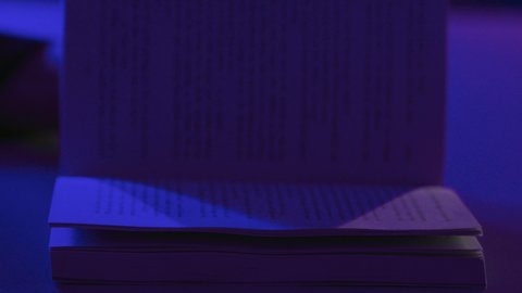 Developing cultural knowledge, reading enjoyable stories and novels, the concept of culture and self-learning, spending free time engaging in the hobby of reading, a close-up shot of the hands of a Saudi Gulf Arab woman holding a book.