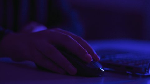 Data entry in electronic systems, working on a laptop, administrative office jobs and professions, integrating modern technology into practical life, content creation, close-up photography of the hand of an Arab Gulf Saudi woman using a laptop mouse.