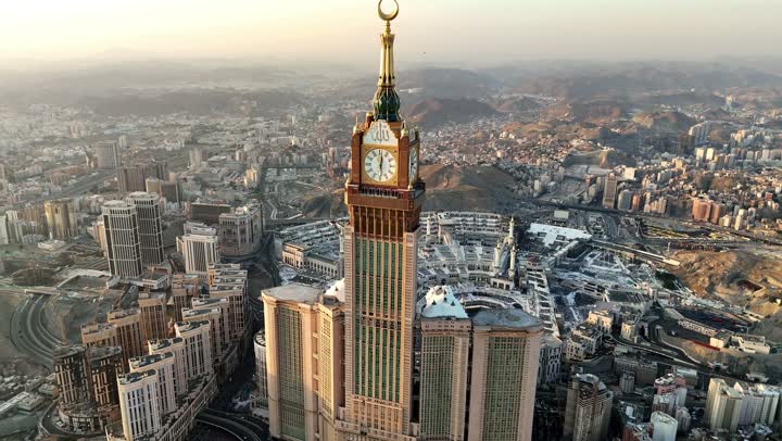 Performing the rituals of Hajj and Umrah, the Clock Tower and modern architectural buildings, aerial drone photography of the city of Mecca in the Kingdom of Saudi Arabia, places and Islamic religious landmarks, modern architectural engineering art for hotels, attractions and drawing Muslims from all over the world.