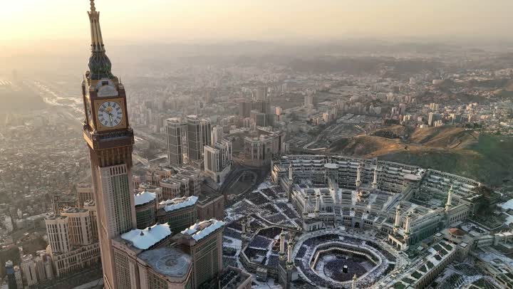 أداء مناسك الحج و العمرة، برج الساعة و أبنية معمارية حديثة, تصوير درون جوي لمدينة مكة المكرمة في المملكة العربية السعودية, أماكن و معالم دينية اسلامية، الفن الهندسي المعماري على الطراز الحديث للفنادق، مناطق جذب واستقطاب المسلمين من جميع انحاء العالم