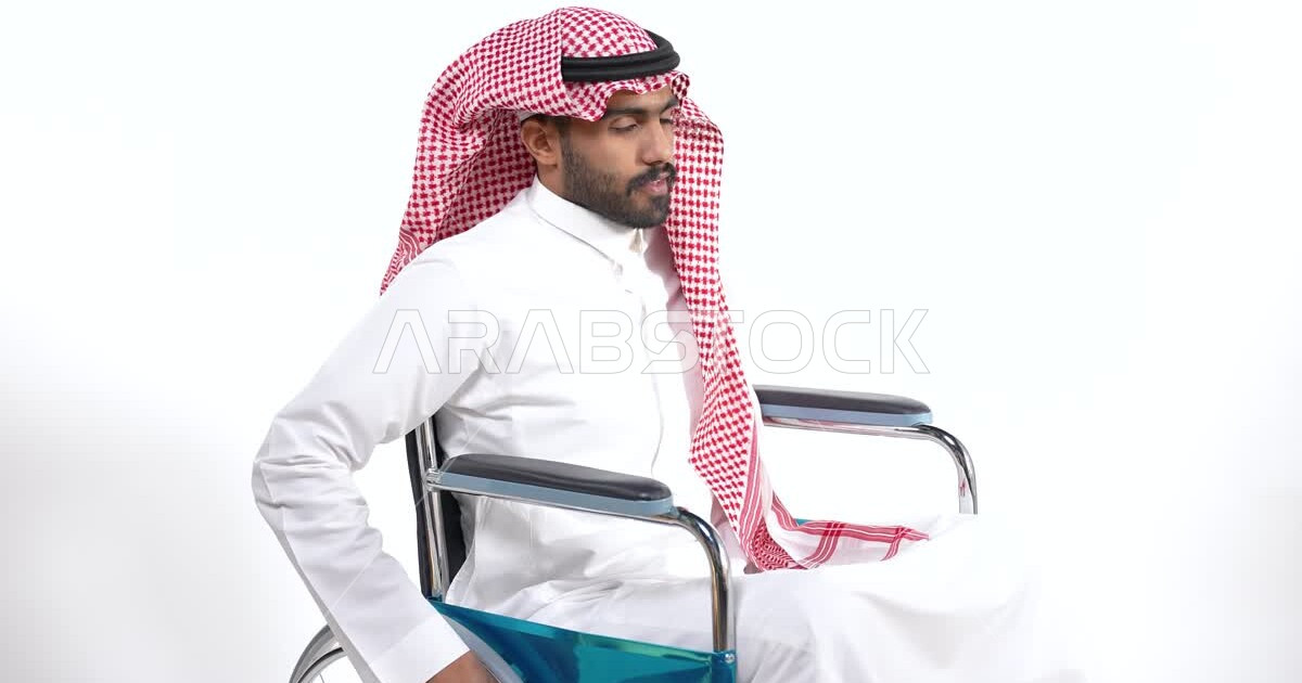 A Saudi Arabian Gulf man of people of determination sits on a
