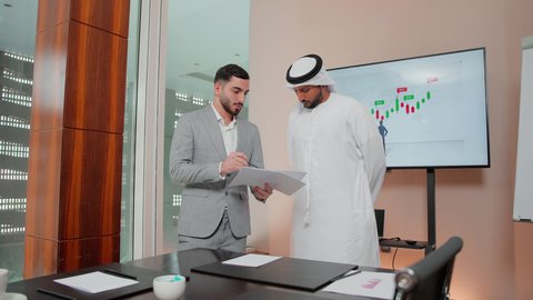 Business development and problem solving, using technology and modern techniques, reviewing work reports, studying new projects, the concept of economic growth and financial investment, following up on the chart, Arab Gulf and Emirati business friends analyzing data on a laptop