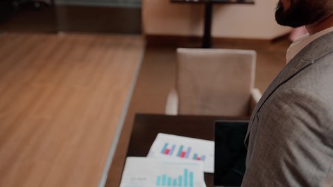 Studying new projects, the concept of economic growth and financial investment, following up on the flowchart, auditing and analyzing project data, using modern technology and techniques at work, two Arab Gulf Emirati colleagues analyzing data on a laptop