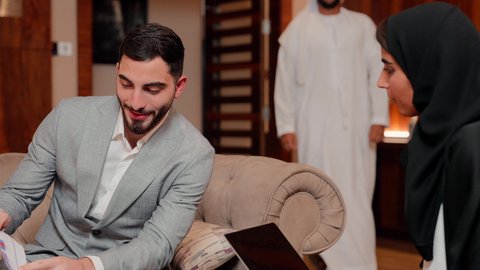 The concept of economic growth and financial investment, reviewing work reports, using technology and modern techniques in work, studying new projects, following up on the flowchart, auditing and analyzing project data, Arab Gulf and Emirati business friends analyzing data on a laptop