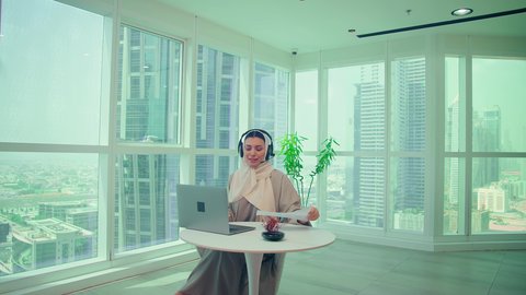 Tracking chart, auditing and analyzing project data, Emirati Gulf Arab woman analyzing data on laptop, studying new projects, stock market ups and downs, economic growth and financial investment