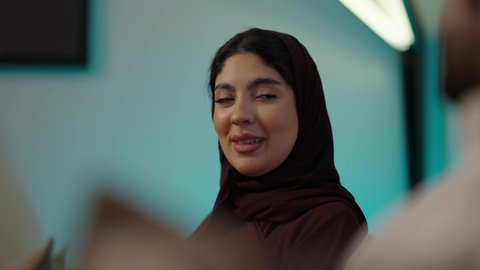 تبادل الأحايث ووجهات النظر، تصوير مقرب لامراه عربيه خليجيه سعودية ترتدي العباءة و الحجاب تقوم بالمناقشة في امر ما ، ايماءات السعادة و السرور