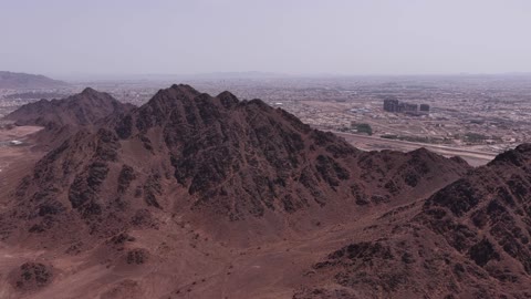 Ancient mountains and rocks in Medina, drone photography of ancient archaeological tourist sites, natural background, a destination for tourists and earth scientists, the mountains and volcanic craters in the Khaybar lava field, landmarks of Medina, natural volcanic fields, natural places in the Kingdom of Saudi Arabia.