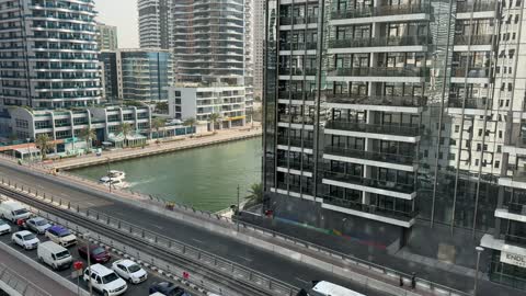 Traffic of cars in the city of Dubai in the United Arab Emirates, the main traffic road in the city of Dubai during the day, drone footage of towers and skyscrapers in the Emirate of Dubai, attracting and drawing tourists from around the world, urban growth and development, tourism in the UAE.