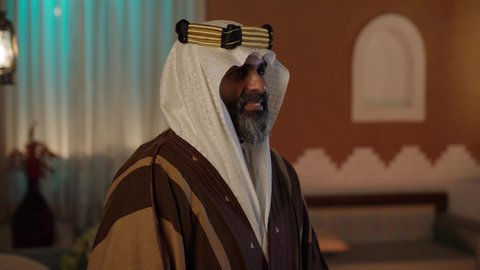 أزياء سعودية تقليدية شعبية، تصوير  لرجل مسن عربي سعودي خليجي يرتدي الزي السعودي الشعبي التقليدي, الزي التراثي للمناسبات الوطنيه, التجول داخل منزل تراثي بتصميم عصري, بيوت تراثيه قديمه, شعبيات, أحياء أثريه قديمه, جوله بين الأحياء الشعبيه