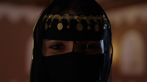 Reviving folk heritage, Saudi Founding Day, traditional Saudi dress with gold embellishments, a Saudi Arabian Gulf woman in a heritage house in Saudi Arabia, historical sites, traditional folk costumes for celebrations and national occasions, the Saudi thobe, traditional Saudi dress, folk accessories