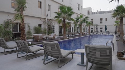 Modern decorations for Arab houses and homes in the Kingdom, architectural geometric art in the construction of apartments and residential villas, the green nature around the swimming pool, design for an Arab building in Saudi Arabia.