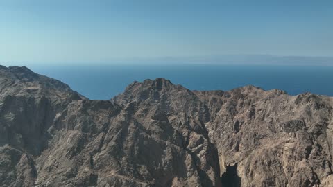 The rock formations and structures in Wadi Tayeb Asm in the Tabuk region, the mountain ranges in desert areas, drone photography of the terrain and rock carvings in the famous historical archaeological sites in Saudi Arabia.