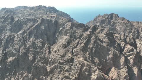 The rock formations and structures in Wadi Tayeb Asm in the Tabuk region, the mountain ranges in desert areas, drone photography of the terrain and rock carvings in the famous historical archaeological sites in Saudi Arabia.