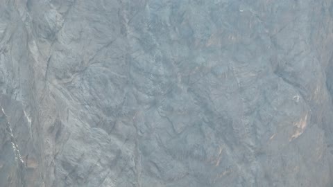 Mountain ranges in desert areas, drone photography of the terrain and rock carvings in famous historical archaeological sites in Saudi Arabia, rock formations and shapes in Wadi Tayeb Asm in the Tabuk region.