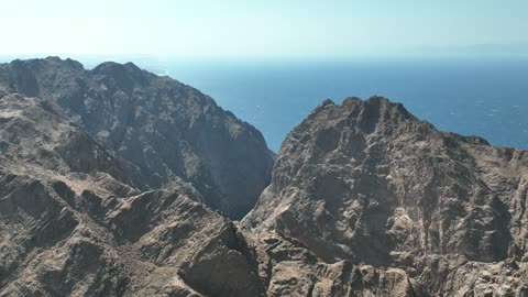 The rock formations and structures in Wadi Tayeb Asm in the Tabuk region, the mountain ranges in desert areas, drone photography of the terrain and rock carvings in the famous historical archaeological sites in Saudi Arabia.