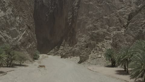 Tourism development project areas, rock formations and structures in Wadi Tayeb Asm in the Tabuk region, mountain ranges in desert areas, drone photography of the terrain and rock carvings in famous historical archaeological sites in Saudi Arabia.