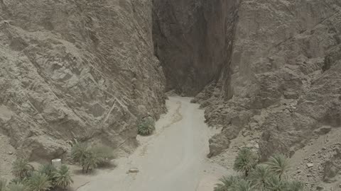 Tourism development project areas, rock formations and structures in Wadi Tayeb Asm in the Tabuk region, mountain ranges in desert areas, drone photography of the terrain and rock carvings in famous historical archaeological sites in Saudi Arabia.