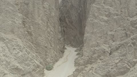 Tourism development project areas, rock formations and structures in Wadi Tayeb Asm in the Tabuk region, mountain ranges in desert areas, drone photography of the terrain and rock carvings in famous historical archaeological sites in Saudi Arabia.