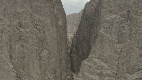 Tourism development project areas, rock formations and structures in Wadi Tayeb Asm in the Tabuk region, mountain ranges in desert areas, drone photography of the terrain and rock carvings in famous historical archaeological sites in Saudi Arabia.