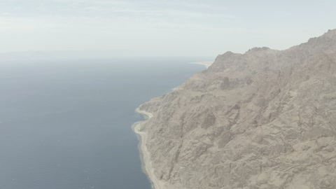 The Neom tourism project road, the eastern coast of the Gulf of Aqaba, areas of tourism development projects, rock formations and structures in Wadi Tayeb Asm in the Tabuk region, mountain ranges in desert areas, drone photography of the terrain and rock carvings in famous historical places in Saudi Arabia.